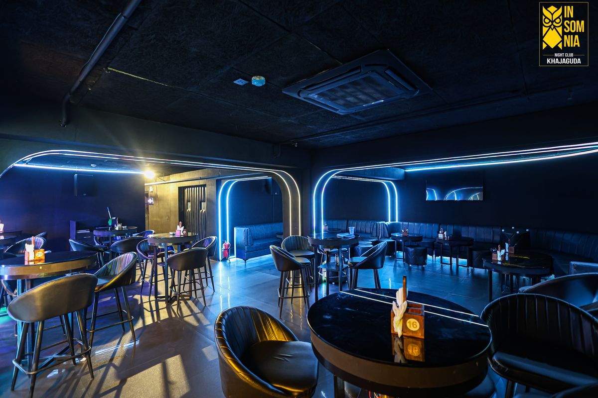Neon-lit lounge seating and cocktail tables — Insomnia Night Club, Khajaguda, Hyderabad
