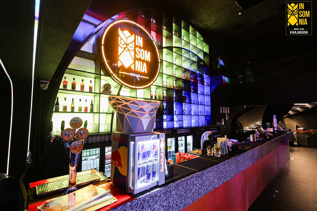 The bar counter and backlit bottle wall — Insomnia Night Club, Khajaguda, Hyderabad