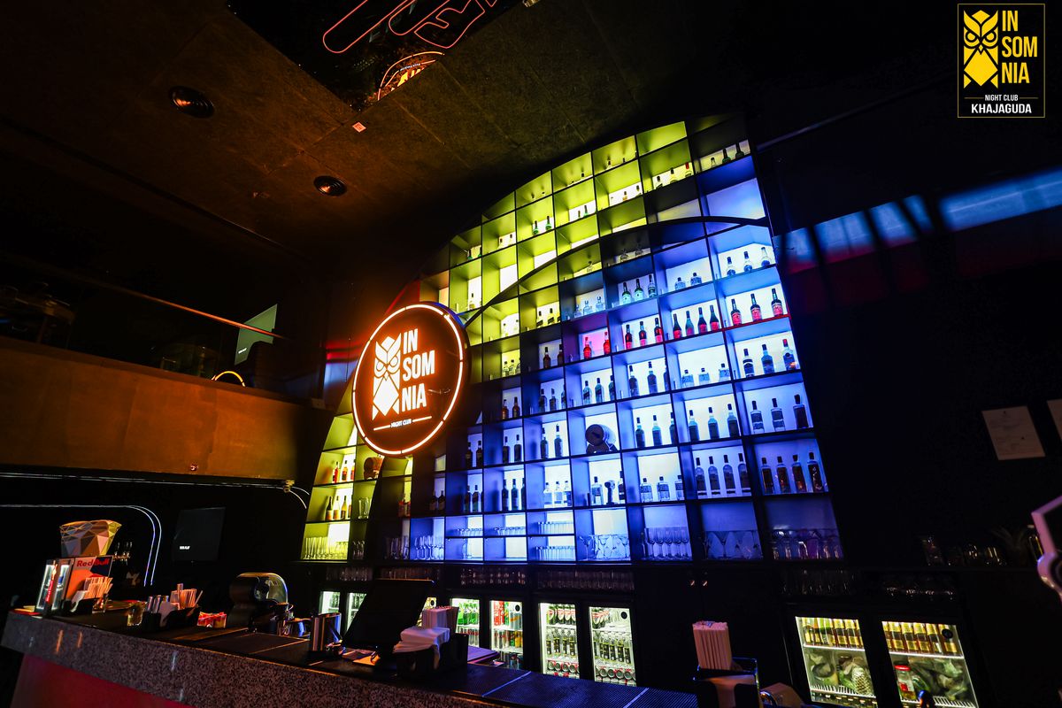 The illuminated bottle wall from the side — Insomnia Night Club, Khajaguda, Hyderabad